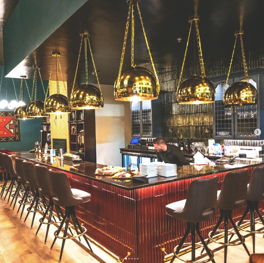 The Village at Silver Star, Kalispell — bar interior with custom tile and gold pendant lighting — general contracting by Homeworks Montana